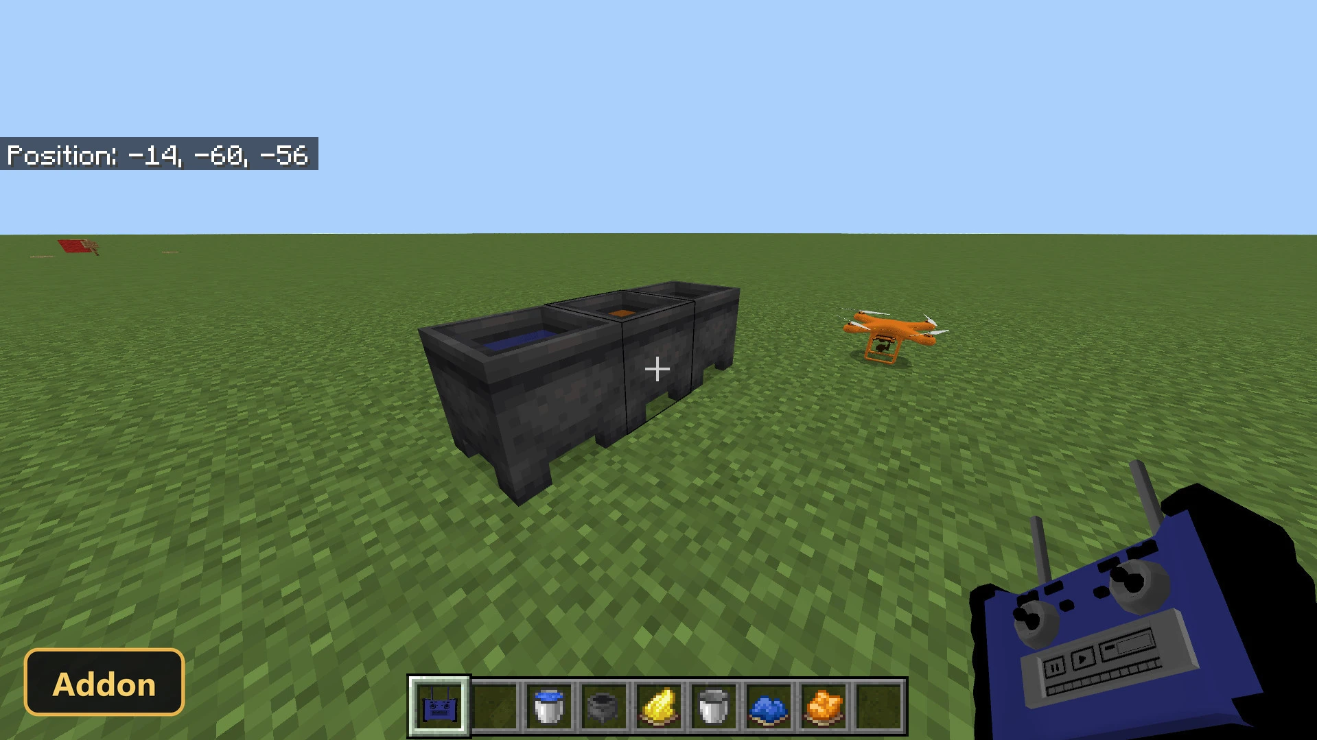 three cauldrons with liquids on grass, player holding a blue remote