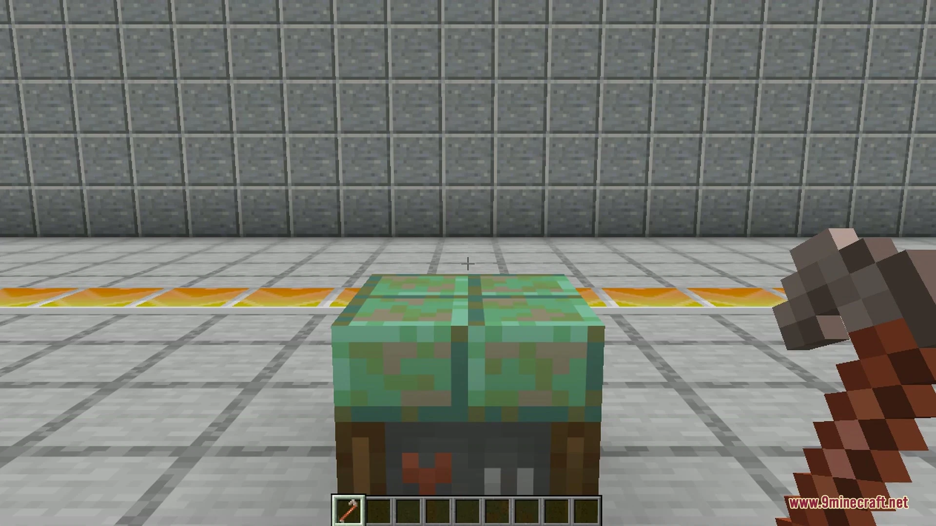 A grey motorcar with large wheels parked on a grassy Minecraft hill