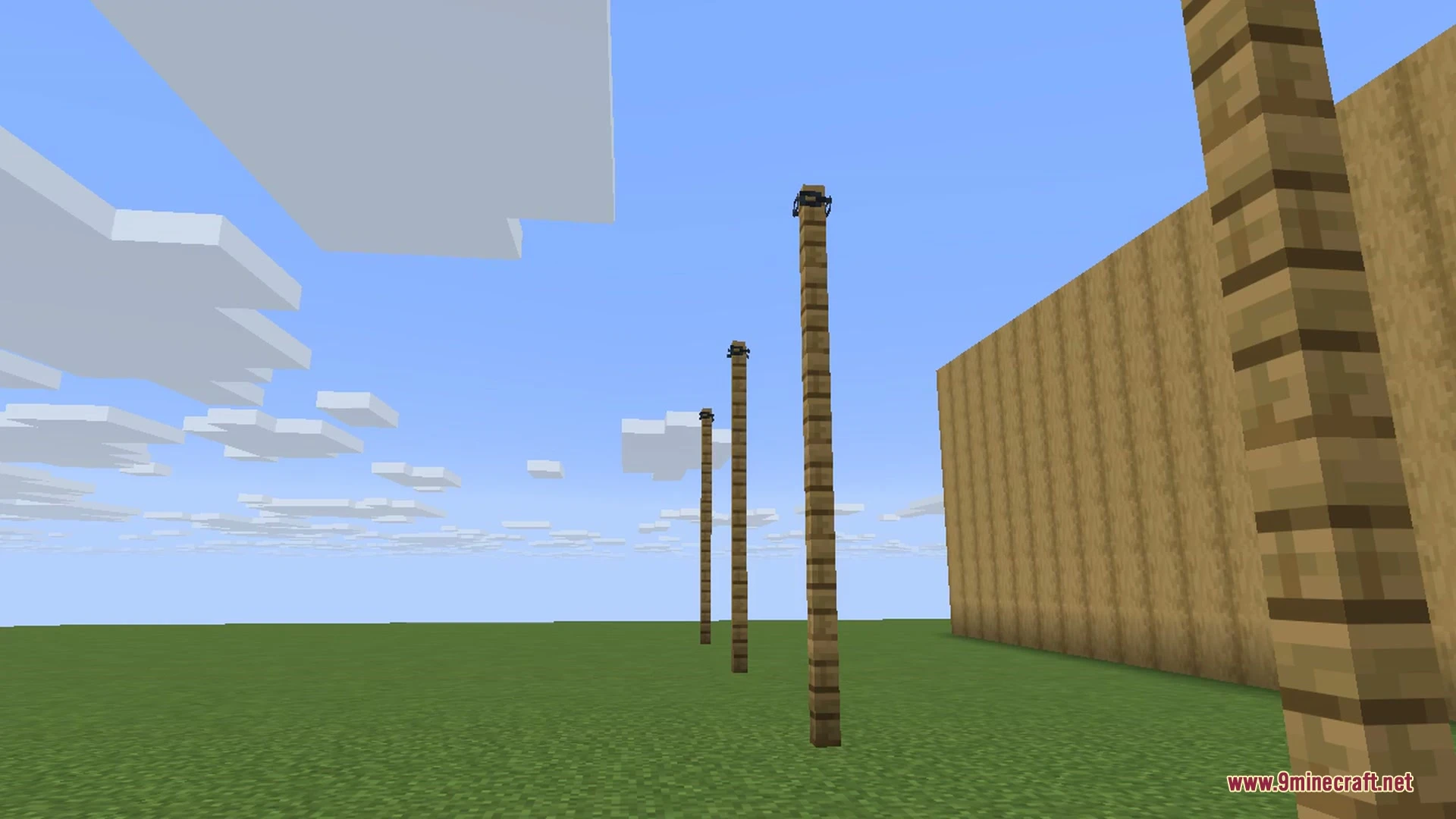 Wooden fence posts connected with sagging chains on a stone brick floor in Minecraft